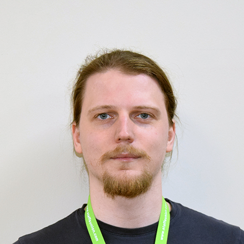 Josh Barnett, Student Voice Coordinator, smiling in front of a white background.