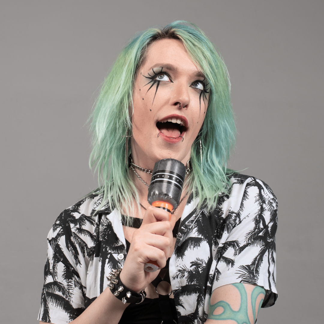 Lilith Drizzle singing into an orange inflatable microphone